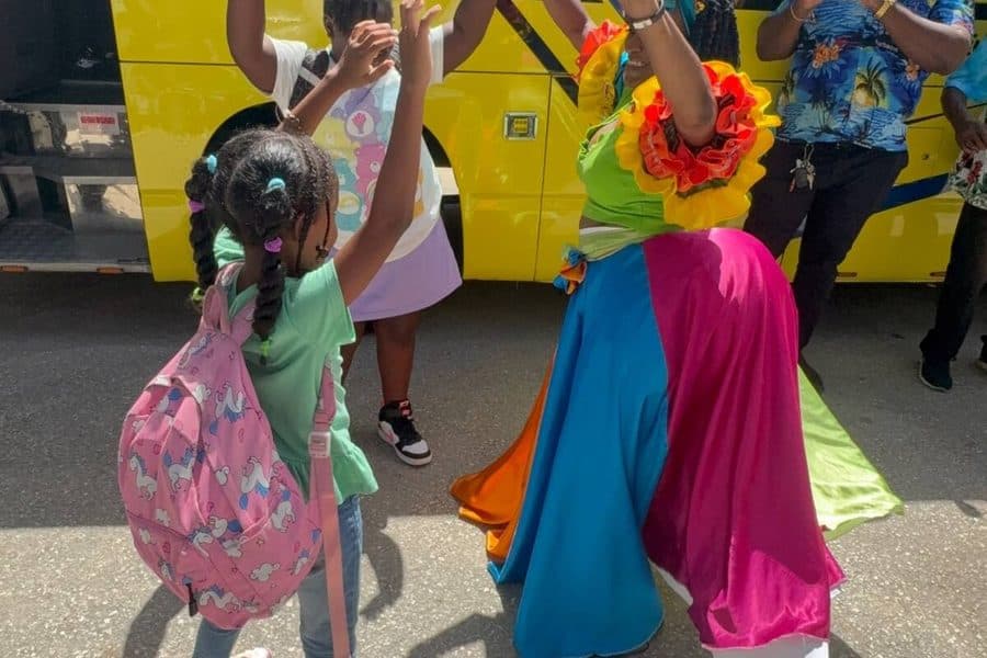 2025 cohort greeting a masquerade performer during a field trip