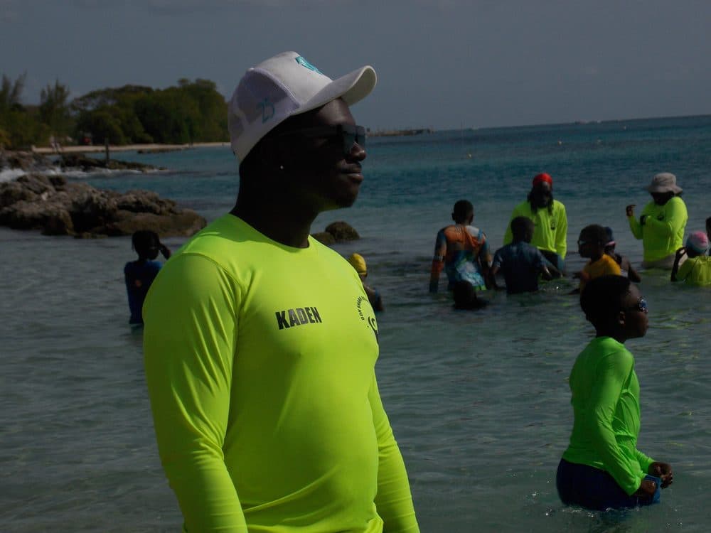 DSA instructor Kaden supporting a young swimmer in a floating safety exercise