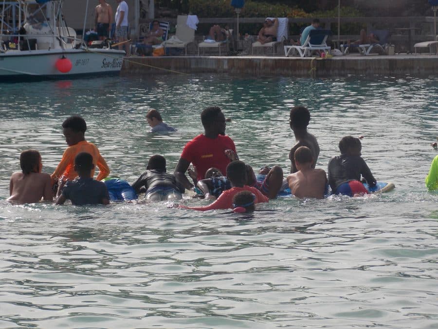 Don Shark Aquatics students and instructors gathered in open water near moored boats