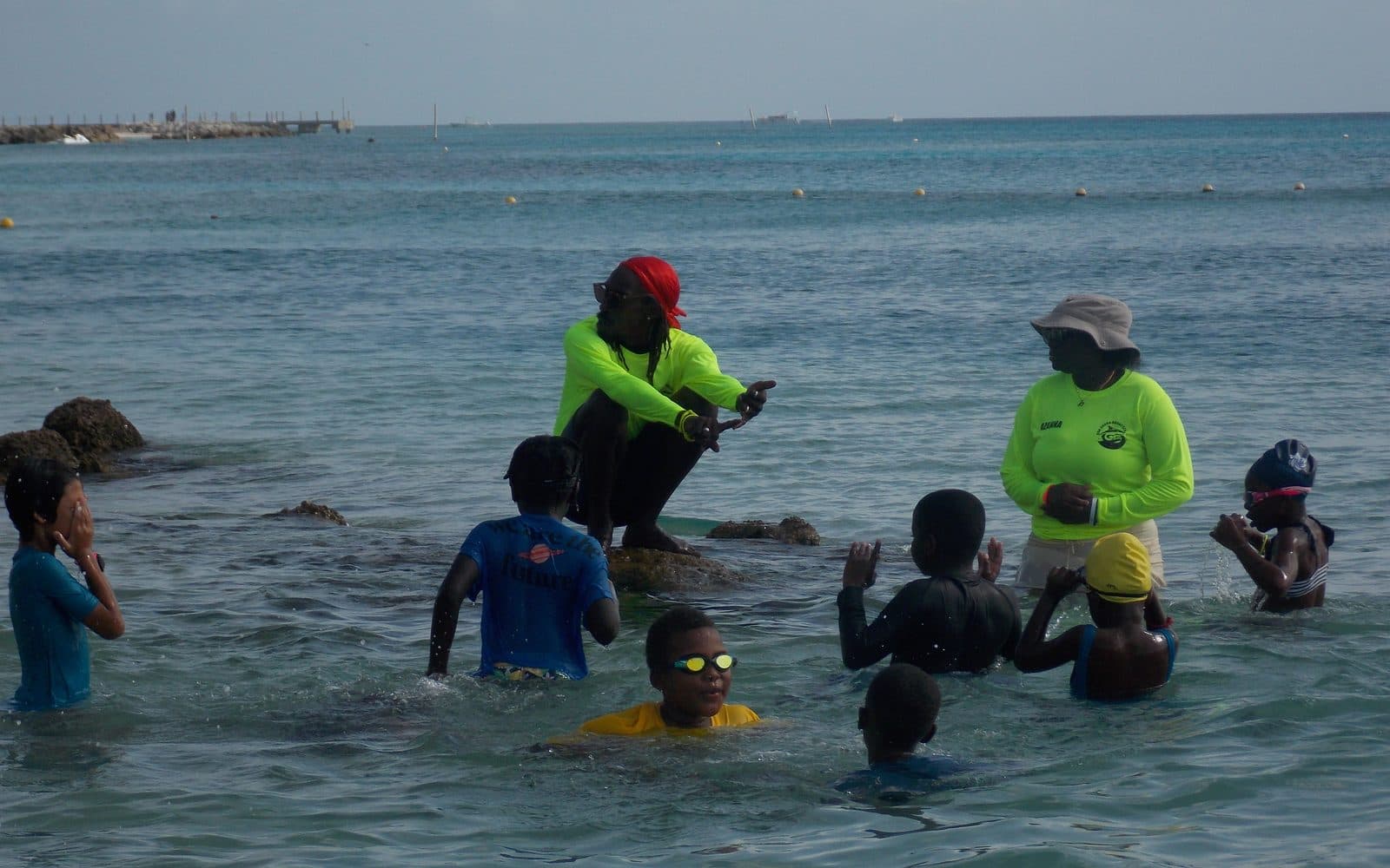 Don Shark Aquatics instructors coaching a group of young swimmers in the open water off Barbados