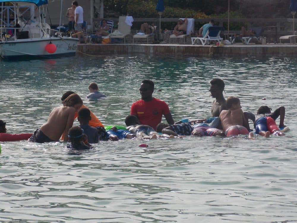 Don Shark Aquatics instructors and students gathered in open water near Bridgetown, Barbados